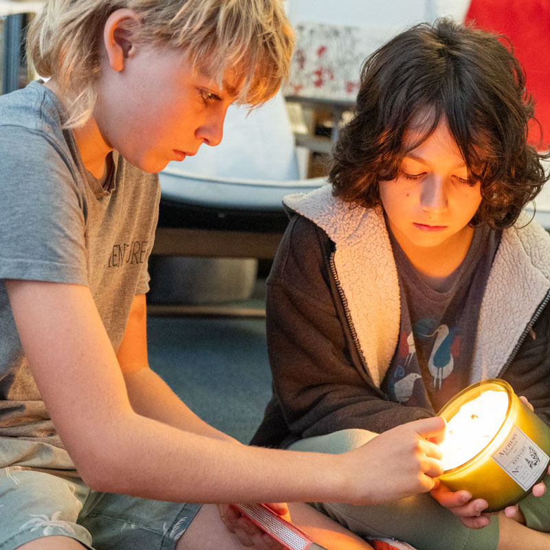 boys lighting a lantern