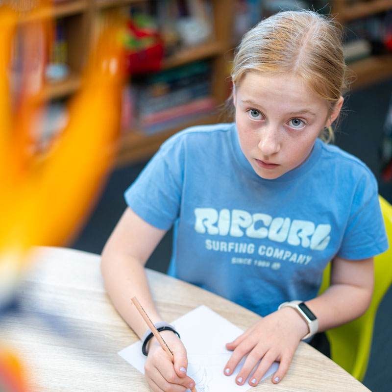 girl looking up from desk